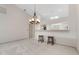 Elegant dining room with a stylish chandelier, breakfast bar, and access to other rooms at 2645 W Marion Ave # 114, Punta Gorda, FL 33950
