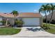 Charming villa features an attached garage, lush landscaping, and a classic red tile roof for a timeless Florida aesthetic at 2645 W Marion Ave # 114, Punta Gorda, FL 33950