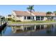 Charming home exterior with a tile roof, lush landscaping, and serene waterfront views at 2645 W Marion Ave # 114, Punta Gorda, FL 33950