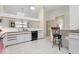Functional kitchen with white cabinets, tile flooring, breakfast bar, and modern black appliances at 2645 W Marion Ave # 114, Punta Gorda, FL 33950