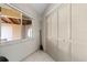 Bright laundry area with louvered closet doors, window, and view to the outside at 2645 W Marion Ave # 114, Punta Gorda, FL 33950