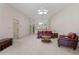 Open-concept living room with comfortable seating, a ceiling fan, and an inviting atmosphere at 2645 W Marion Ave # 114, Punta Gorda, FL 33950