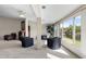 Light filled living room with neutral carpet, black leather chairs and scenic water views at 2645 W Marion Ave # 114, Punta Gorda, FL 33950
