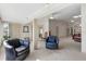 Bright living room featuring neutral walls, plush carpeting and comfortable black leather furniture at 2645 W Marion Ave # 114, Punta Gorda, FL 33950