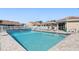 Community pool area with lounge chairs, a tiki hut, and well-maintained landscaping at 2645 W Marion Ave # 114, Punta Gorda, FL 33950