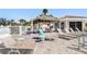 Community pool area with lounge chairs, a tiki hut, and well-maintained landscaping at 2645 W Marion Ave # 114, Punta Gorda, FL 33950