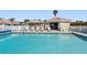 Community pool with lounge chairs and hut in the background at 2645 W Marion Ave # 114, Punta Gorda, FL 33950