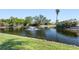 Scenic view of serene lake with water fountain and lush landscaping in a peaceful community setting at 2645 W Marion Ave # 114, Punta Gorda, FL 33950