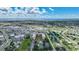An aerial view captures a condo with a pool, tennis court, and scenic water views in the distance at 3006 Caring Way # 329, Port Charlotte, FL 33952