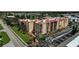 Aerial view of building, showcasing landscaped grounds, parking, and proximity to the road at 3006 Caring Way # 329, Port Charlotte, FL 33952