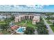 Community aerial view showcasing the pool, lush landscape and multiple buildings at 3006 Caring Way # 329, Port Charlotte, FL 33952