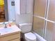 Cozy bathroom featuring a white vanity, toilet, and enclosed shower at 3006 Caring Way # 329, Port Charlotte, FL 33952