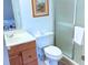 Well-lit bathroom featuring a vanity, toilet, and shower with glass doors at 3006 Caring Way # 329, Port Charlotte, FL 33952