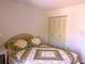 Comfortable bedroom showing a neatly made bed and a closet at 3006 Caring Way # 329, Port Charlotte, FL 33952