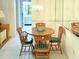 Cozy dining area with round table, decorative chandelier, and mirror accent wall at 3006 Caring Way # 329, Port Charlotte, FL 33952
