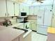 Clean kitchen offering white appliances, efficient layout, and abundant cabinetry at 3006 Caring Way # 329, Port Charlotte, FL 33952