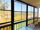 Screened lanai offering views of the manicured grounds and palms at 3006 Caring Way # 329, Port Charlotte, FL 33952