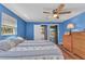 Bedroom showcasing the ceiling fan and the sliding glass door that leads to a backyard swimming pool at 3110 Brooklyn Ave, Port Charlotte, FL 33952