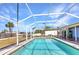 Spacious in-ground pool within a screened enclosure offers a refreshing retreat in the backyard at 3110 Brooklyn Ave, Port Charlotte, FL 33952