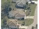Aerial view of a home with a screened-in pool, well-maintained lawn, and an attached two-car garage at 32 Bariloche Dr, Punta Gorda, FL 33983