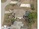 Aerial view of a home with a screened-in pool, well-maintained lawn, and an attached two-car garage at 32 Bariloche Dr, Punta Gorda, FL 33983