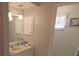 Bathroom with vanity and framed mirror features neutral walls and updated fixtures at 32 Bariloche Dr, Punta Gorda, FL 33983