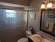 Well-lit bathroom featuring a shower with glass door, framed mirror, and vanity with sink at 32 Bariloche Dr, Punta Gorda, FL 33983