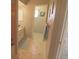 Hallway bathroom features unique tile flooring, sink with cabinets, and a pink tiled shower at 32 Bariloche Dr, Punta Gorda, FL 33983