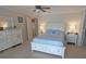 Well-lit bedroom featuring a ceiling fan, matching dressers, and blue patterned bedding at 32 Bariloche Dr, Punta Gorda, FL 33983