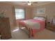 Bright bedroom with a comfortable bed, wood furnishings, and a sunny window at 32 Bariloche Dr, Punta Gorda, FL 33983