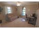 Cozy bedroom featuring a comfortable tan sofa, desk, and bright windows at 32 Bariloche Dr, Punta Gorda, FL 33983
