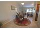 Charming dining area with a glass-top table and wicker chairs, adjacent to the living room at 32 Bariloche Dr, Punta Gorda, FL 33983