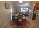 Cozy dining area open to the living room, featuring a round table and wicker chairs at 32 Bariloche Dr, Punta Gorda, FL 33983