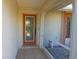 Inviting front porch features a decorative door with sidelights and decorative accents at 32 Bariloche Dr, Punta Gorda, FL 33983