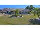 Charming home features a well-maintained lawn with tropical landscaping and a two-car garage at 32 Bariloche Dr, Punta Gorda, FL 33983