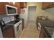 Kitchen features white oven and range, dark countertops, stainless steel sink and wood cabinets at 32 Bariloche Dr, Punta Gorda, FL 33983
