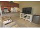 Inviting living room featuring a TV and access to the kitchen with breakfast bar at 32 Bariloche Dr, Punta Gorda, FL 33983