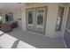 Covered patio with a doorway leading to the pool area, and wicker furniture at 32 Bariloche Dr, Punta Gorda, FL 33983