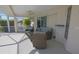 Charming covered patio with wicker furniture and a ceiling fan for outdoor comfort at 32 Bariloche Dr, Punta Gorda, FL 33983
