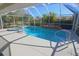 Stunning screened-in pool area with a built-in spa and lush landscaping at 32 Bariloche Dr, Punta Gorda, FL 33983