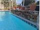 Beautiful stone waterfall feature adds a natural touch to this sparkling screened pool at 32 Bariloche Dr, Punta Gorda, FL 33983