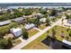 Aerial view of the home, street, and neighborhood with beautiful landscaping and canal access at 3436 Discovery Dr, Punta Gorda, FL 33983