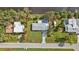 Aerial view of the home, showcasing its well-manicured lawn, long driveway, and proximity to the water at 3436 Discovery Dr, Punta Gorda, FL 33983