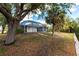 A spacious backyard features a screened-in lanai and a beautiful landscape with mature trees at 3436 Discovery Dr, Punta Gorda, FL 33983