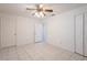A bright bedroom featuring tile flooring and multiple closet doors at 3436 Discovery Dr, Punta Gorda, FL 33983