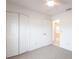 Bedroom featuring neutral carpet, closet, ceiling fan with light, and entry to another room at 3436 Discovery Dr, Punta Gorda, FL 33983
