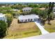 A charming single-story home with a light-colored exterior, large front yard, and a canal view in the backyard at 3436 Discovery Dr, Punta Gorda, FL 33983