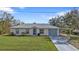 Charming single-story home with a well-maintained lawn and attached carport at 3436 Discovery Dr, Punta Gorda, FL 33983