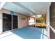 Relaxing screened lanai with blue painted flooring and sliding door access to the backyard at 3436 Discovery Dr, Punta Gorda, FL 33983