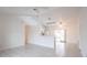 A bright living room space with tile flooring that opens to the kitchen and leads to sliding glass doors at 3436 Discovery Dr, Punta Gorda, FL 33983